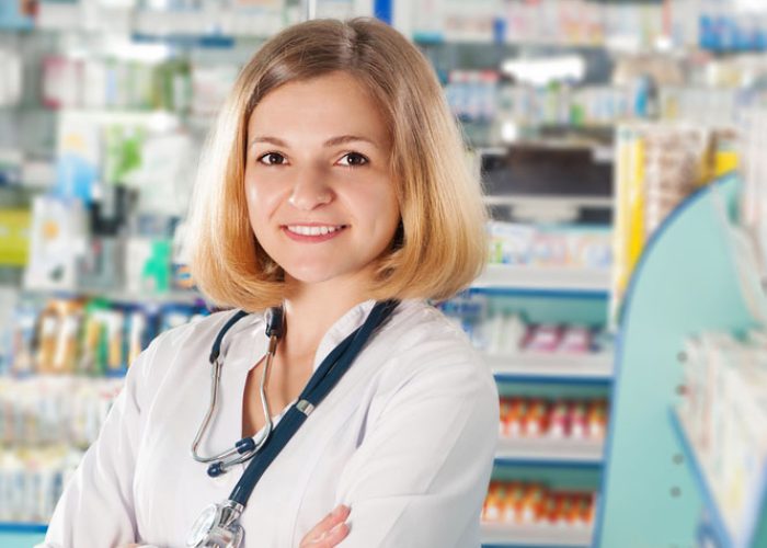 Young pharmacist with phonendoscope in drugstore